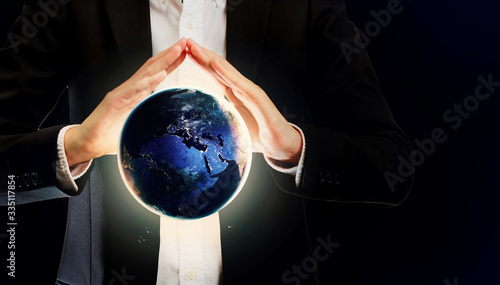 Earth day, saving energy concept, Man hands protecting Earth at night, Elements of this image furnished by NASA
