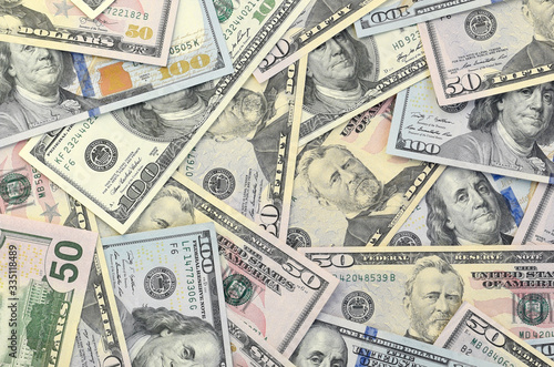 Many one hundred and fifty dollar bills on flat background surface close up. Flat lay top view photo