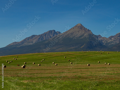 Beautiful summer panorama over Spisz highland with sheaves of hay to Tatra mountains, Poland © Beata