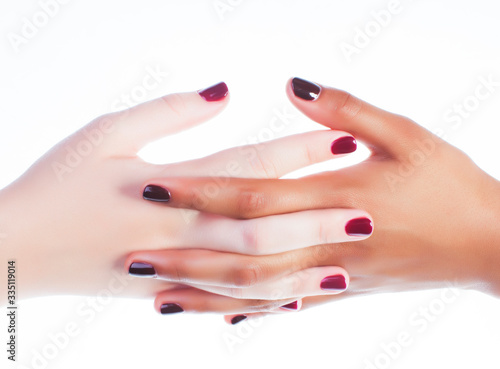two different nathion manicured hands on white isolated, african with caucasian