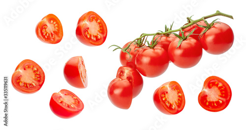 Cherry tomatoes. Pieces of tomatoes are cut in half and whole vegetables on a branch. Isolated on a white background