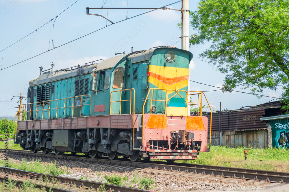 Obraz premium Old railway train rides on rails. Old train