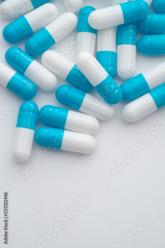 Blue and white capsules pill spilled out.