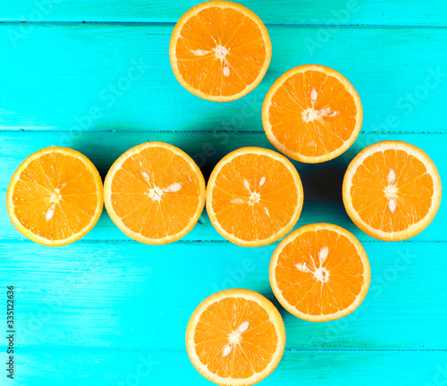 cut orange on a blue wooden background
