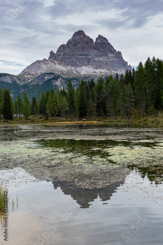 Italian Dolomites reflecting on the lake of Antorno on a cloudy autumn day