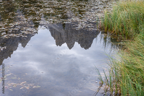 Italian Dolomites reflecting on the lake of Antorno on a cloudy autumn day