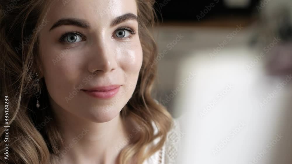a girl with a natural appearance, in a pink dress, draws a picture and looks at the camera, she smiles beautifully a girl with a natural appearance, in a pink dress, draws a picture and looks at the camera, she smiles beautifully