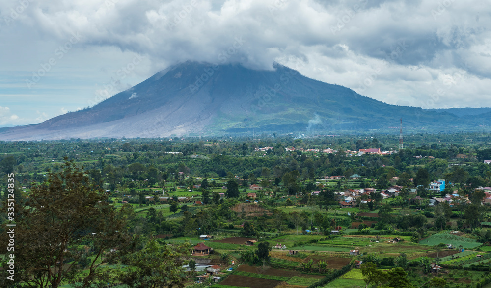 SInabung active volcano close distance summit in cloud visible from Berastagi, North Sumatra, Indonesia