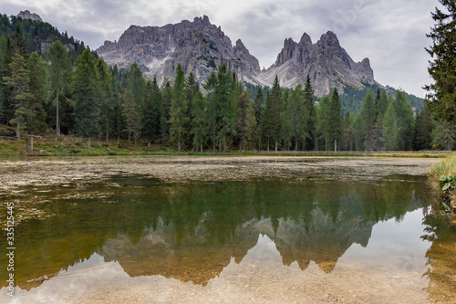 Italian Dolomites reflecting on the lake of Antorno on a cloudy autumn day