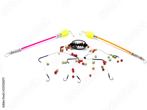 Bait feeder,  bite alarm and plastic bait isolated on white background. Composition of tools for professional fishing. 