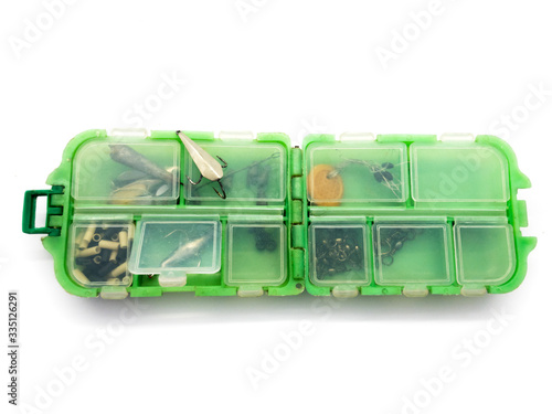 Box with hooks isolated on a white background. Metal hooks in the box. Fishing box.