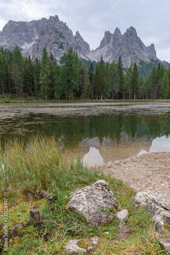 Italian Dolomites reflecting on the lake of Antorno on a cloudy autumn day