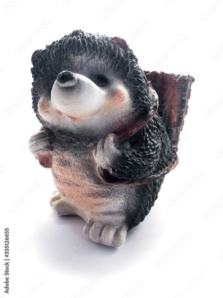 Obraz premium Piggy bank isolated on a white background. Piggy bank in the form of a hedgehog. Piggy bank and banknotes.