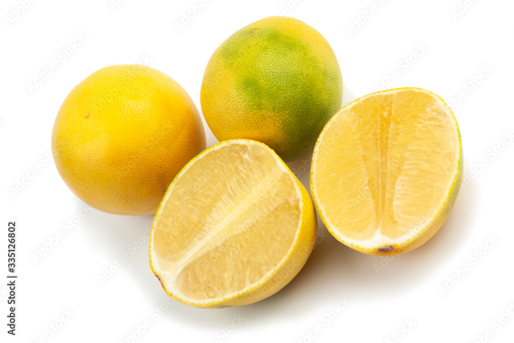 two whole and two halves of yellow-green grapefruit on a white background, isolate two whole and two halves of yellow-green grapefruit on a white background, isolate
