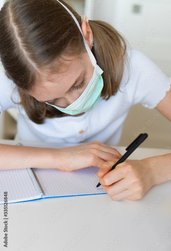 Little girl doing school homework during quarantine. Little girl doing school homework during quarantine.