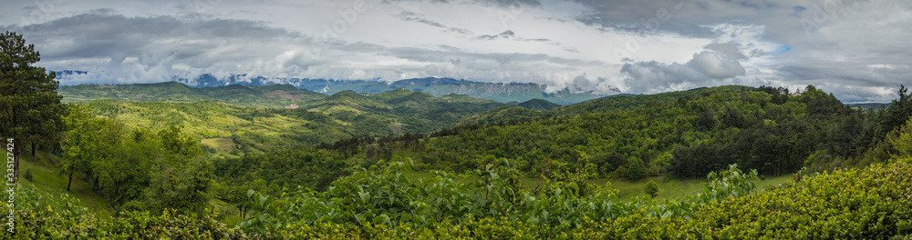 Panoramic view from the village of Stanjel, Slovenia, on a cold cloudy spring day with dense clouds covering the sky.