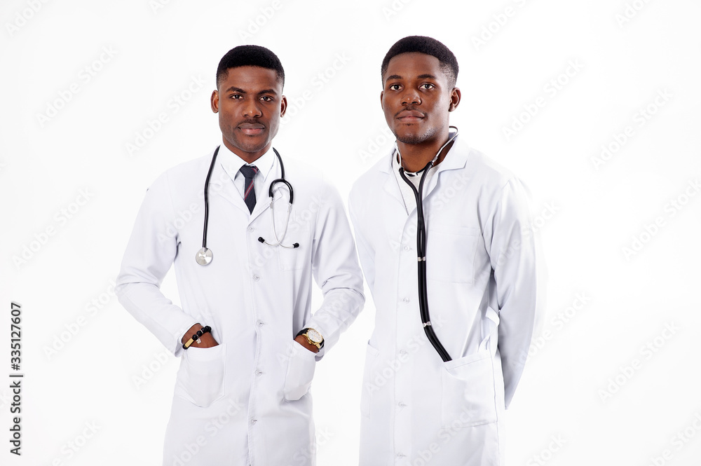 Two young african doctors on an isolated white background with a phonendoscope Two young african doctors on an isolated white background with a phonendoscope