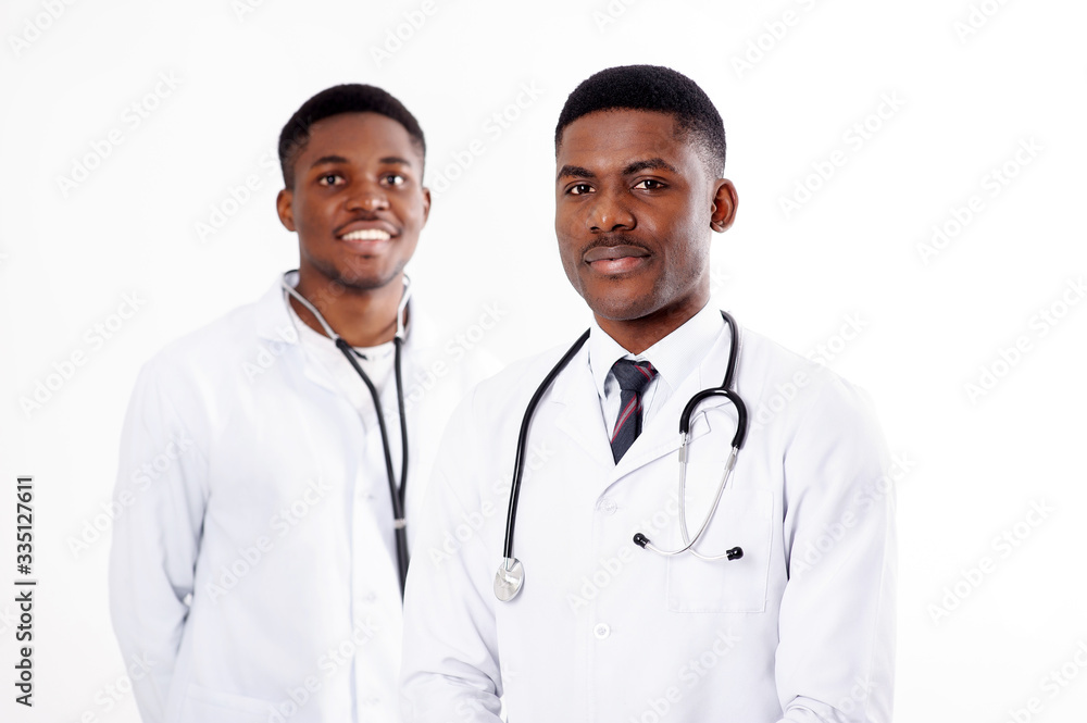 Two young african doctors on an isolated white background with a phonendoscope Two young african doctors on an isolated white background with a phonendoscope