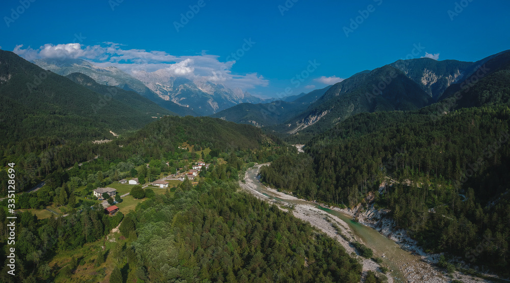 Aerial panorama of Resia valley looking towards the village of Stolvizza, torrente Resiaand Rio Lommig on a warm summer day in Italian Alps