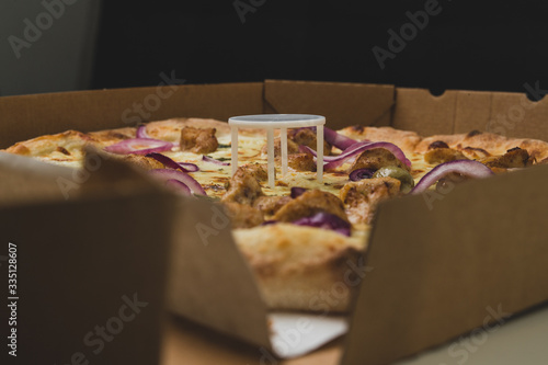 Quadro em tela Pizza saver or ottoman, known also as pizza table, used in pizza deliveries to save the pizza being squished in a cardboard box