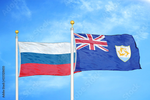 Russia and Anguilla two flags on flagpoles and blue cloudy sky photo