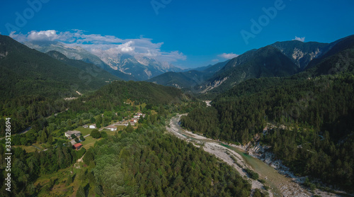 Aerial panorama of Resia valley looking towards the village of Stolvizza, torrente Resiaand Rio Lommig on a warm summer day in Italian Alps