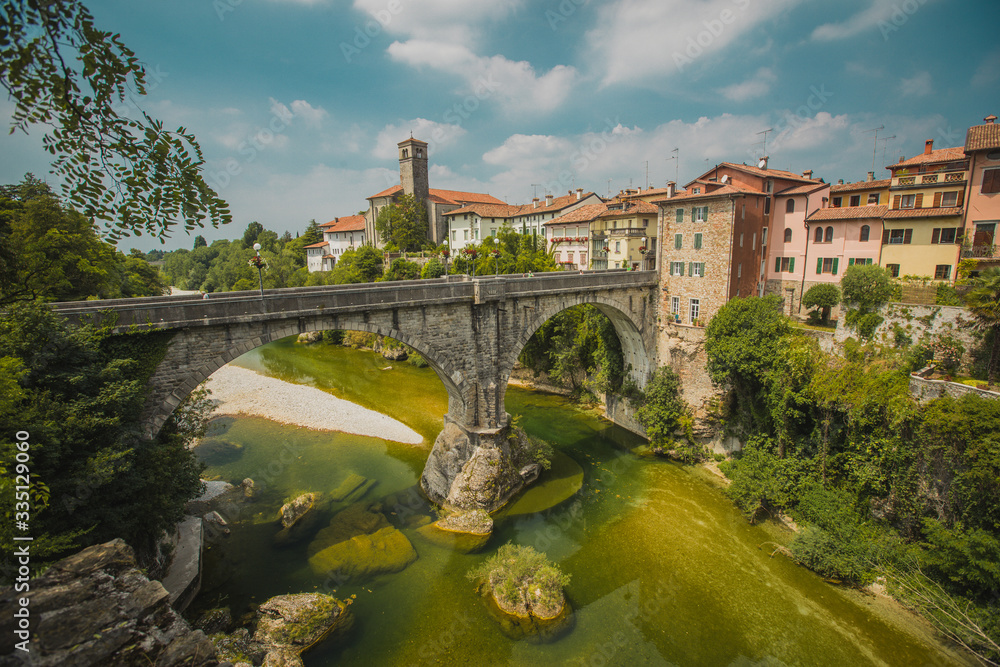 Horizontal photo of the town of Cividale del Friuli in Eastern italy on a picturesque sunny day. On picture visible also ponte del Diavolo above Nadige river. Horizontal photo of the town of Cividale del Friuli in Eastern italy on a picturesque sunny day. On picture visible also ponte del Diavolo above Nadige river.