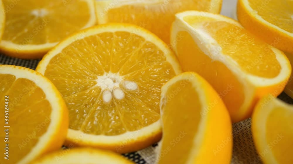 Lots of sliced flesh oranges rotates on table. Healthy fruit background Lots of sliced flesh oranges rotates on table. Healthy fruit background