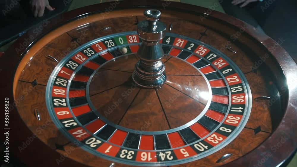 A shot of a casino roulette in motion,the ball stops at 26 black thirty six/Better luck next time A shot of a casino roulette in motion,the ball stops at 26 black thirty six/Better luck next time