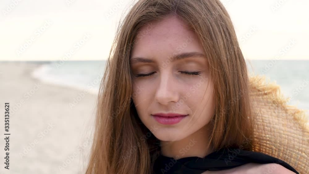 Beautiful brunette girl in a white linen dress walking by seaside Beautiful brunette girl in a white linen dress walking by seaside