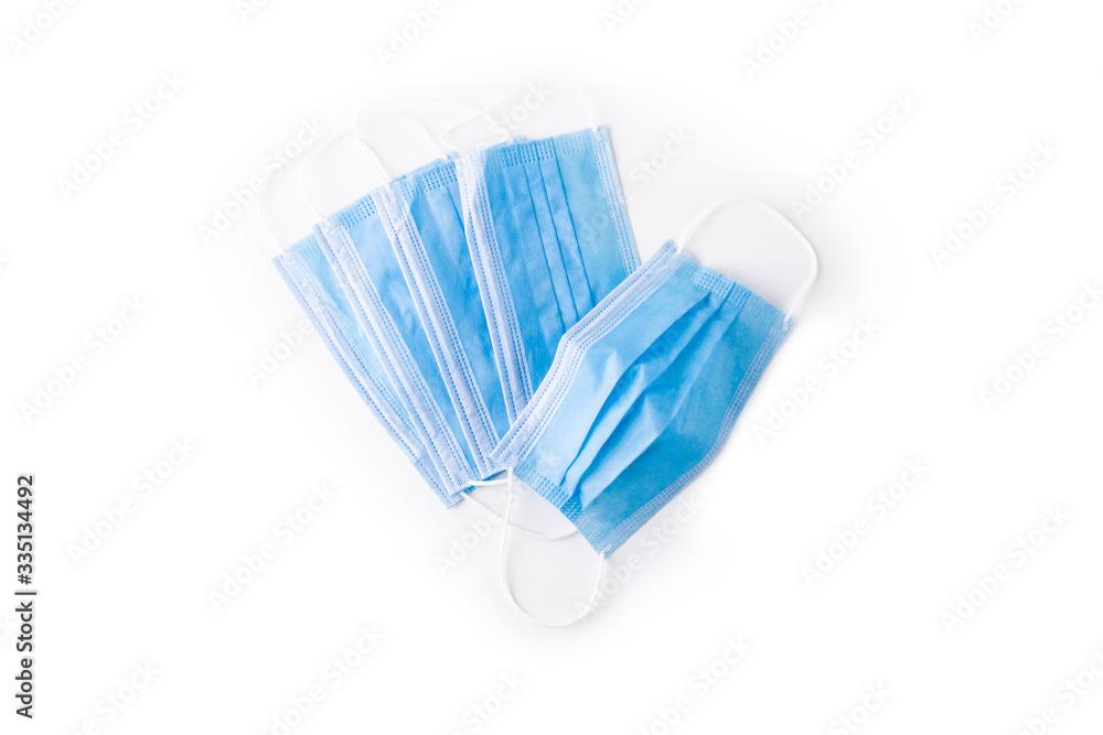 Top view coronavirus medical respiratory protection mask. Covid-19 virus safety blue masks isolated on white background. Surgical hygienics bandage face. Antiviral infection mask with clipping path Top view coronavirus medical respiratory protection mask. Covid-19 virus safety blue masks isolated on white background. Surgical hygienics bandage face. Antiviral infection mask with clipping path