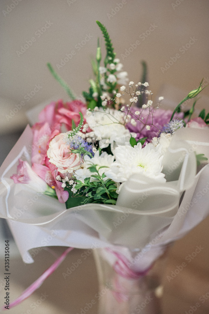 A beautiful multicolored bouquet of roses, eustomas and chrysanthemums. Soft focus. A beautiful multicolored bouquet of roses, eustomas and chrysanthemums. Soft focus.