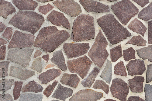 Background, texture and close-up of a wall decorated with flat natural stones