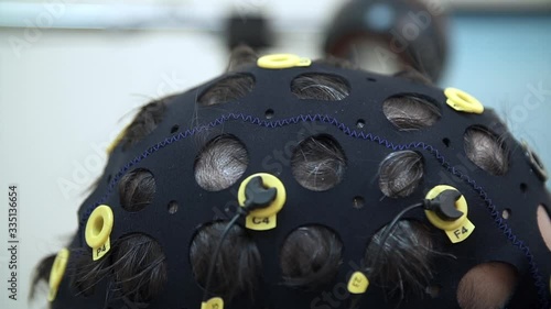 Doctor preparing man for brain scan in hospital. The installation of the sensors for the EEG of the brain