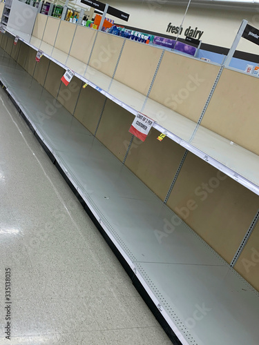 Dayton, OH- Mar 25, 2020: Bare shelves for toilet paper at Meijer grocery store. Not a single role or package available for purchase due to hording from coronavirus photo