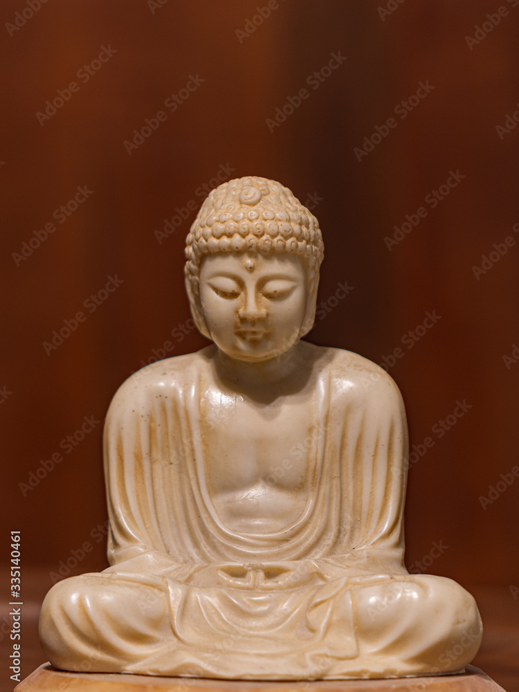 Statuette of Gautama Buddha in light marble in a prayer position Statuette of Gautama Buddha in light marble in a prayer position
