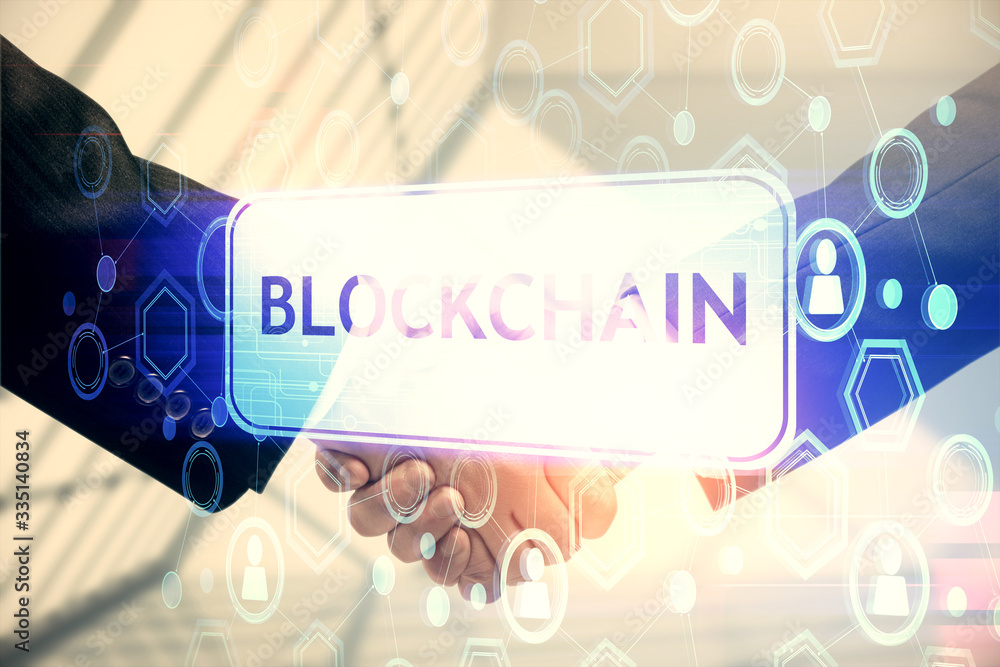 Double exposure of blockchain hologram and handshake of two men. Crypto business concept. Double exposure of blockchain hologram and handshake of two men. Crypto business concept.