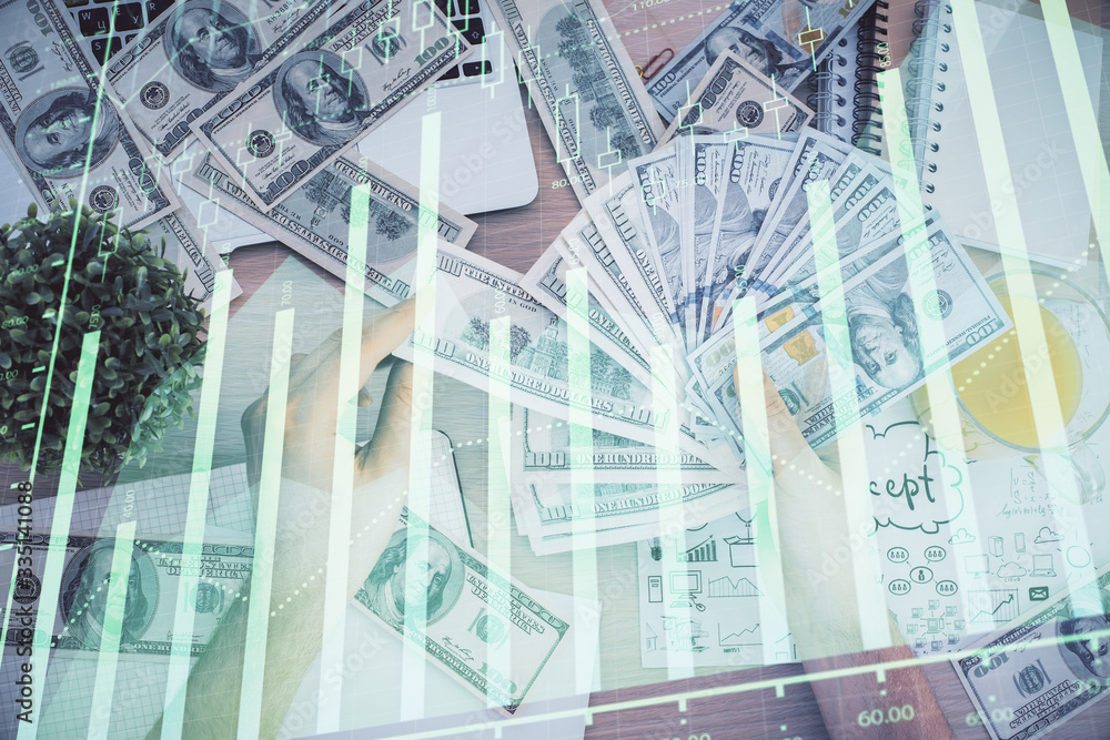 Multi exposure of financial graph drawing hologram and USA dollars bills and man hands. Analysis concept. Multi exposure of financial graph drawing hologram and USA dollars bills and man hands. Analysis concept.