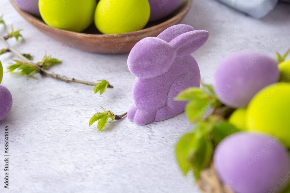easter green and purple eggs with rabbit on a light surface easter green and purple eggs with rabbit on a light surface