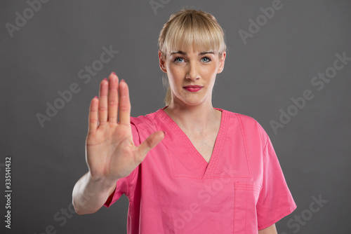 Wallpaper Mural Portrait of young attractive female nurse showing stop Torontodigital.ca