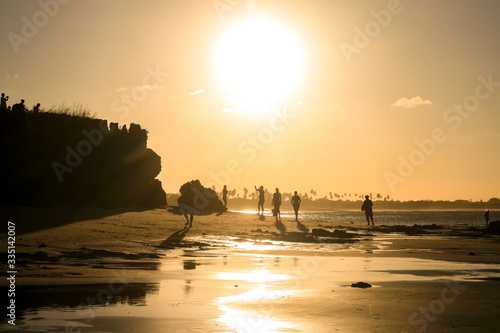 Sunset light reflecting on the wet sand