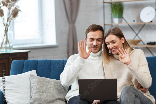 Stay home. Portrait of smiling family using laptop for a online meeting, video call, video conference with parents, children, relatives. Self-isolation. Spending time at home in quarantine period.