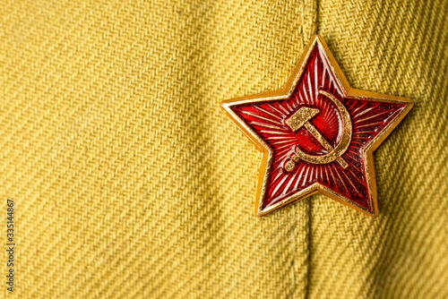 Billede på lærred Old soviet military badge with hammer and sickle on light green cloth headgear