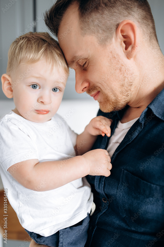 Sensual photo of dad and son. Dad gently hugs his beloved little son Sensual photo of dad and son. Dad gently hugs his beloved little son