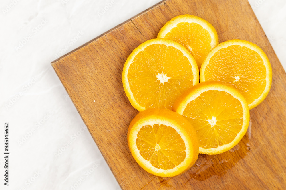Flat lay above sliced orange on the cutting board with copy space Flat lay above sliced orange on the cutting board with copy space