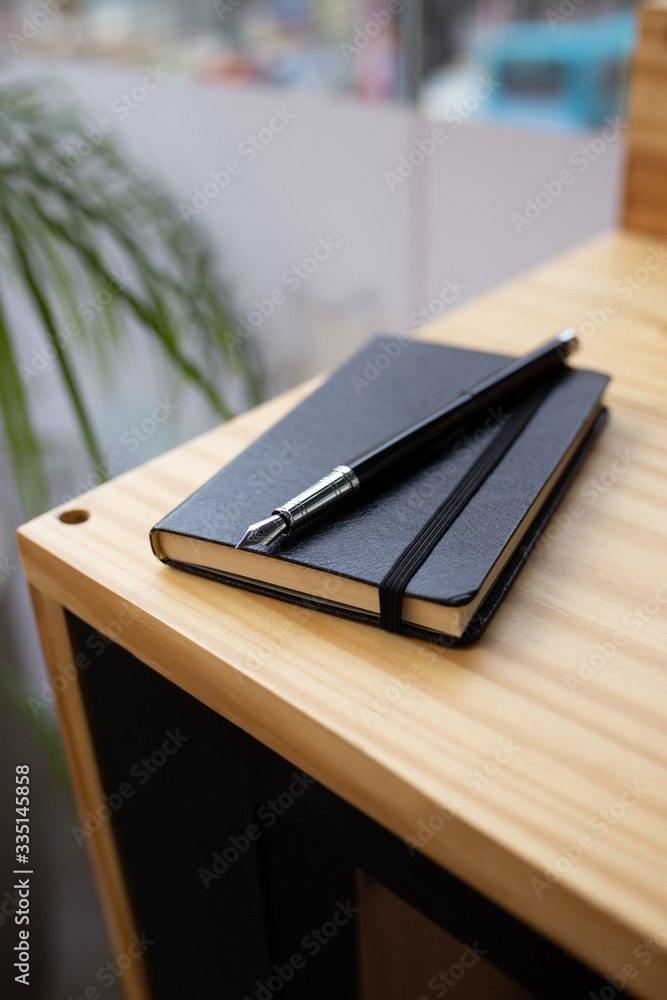 One white smartphone on a wooden desk One white smartphone on a wooden desk