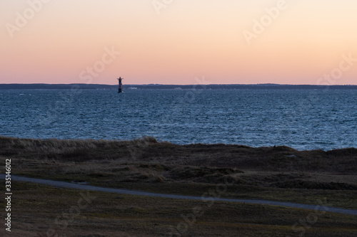 Sunset with the old lighthouse Svinbadan built in 1958 and located in Oresund, Viken, Scania, Sweden