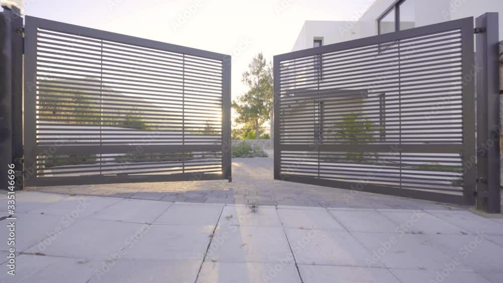 Garden Gate Opening to modern villa, modern house entrance sunshine Garden Gate Opening to modern villa, modern house entrance sunshine