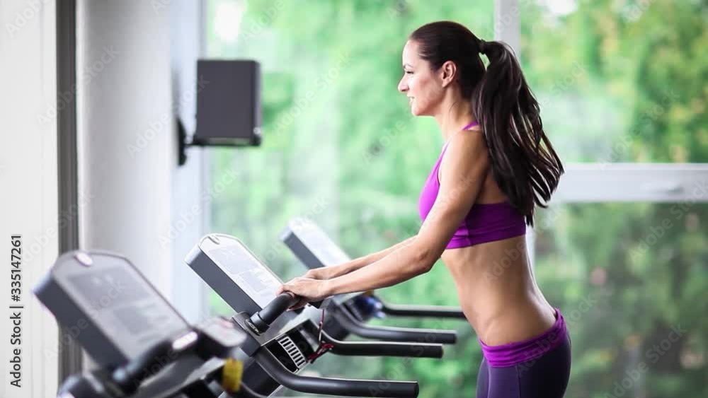 Woman running on treadmill, sports training 5x slow motion Woman running on treadmill, sports training 5x slow motion