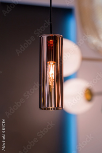 Modern streamlined copper chandelier. Glass shaped pendant lamp interesting form